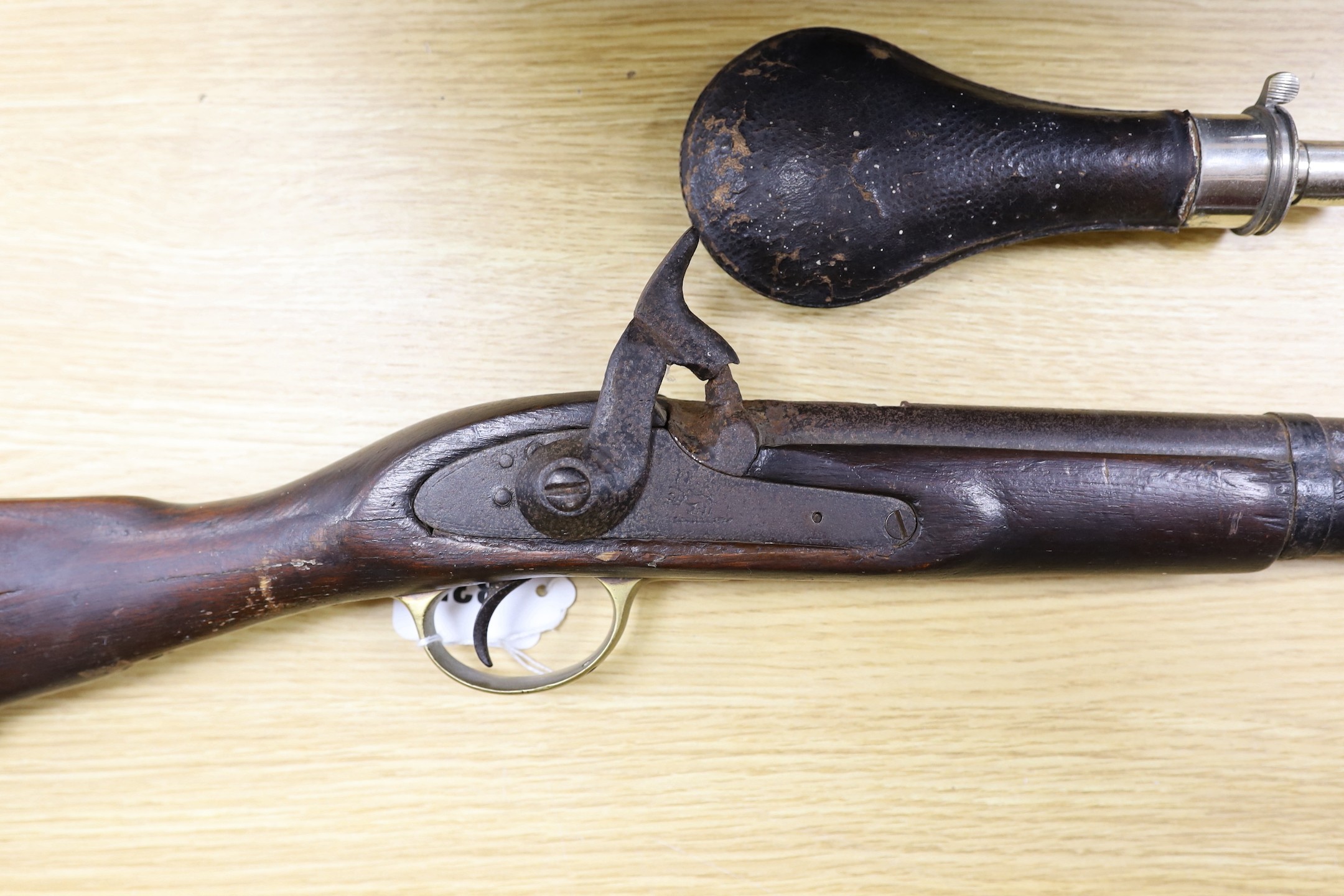 A 19th century percussion cap carbine musket with name stamped to lock plate and a shot flask, musket 94cms long